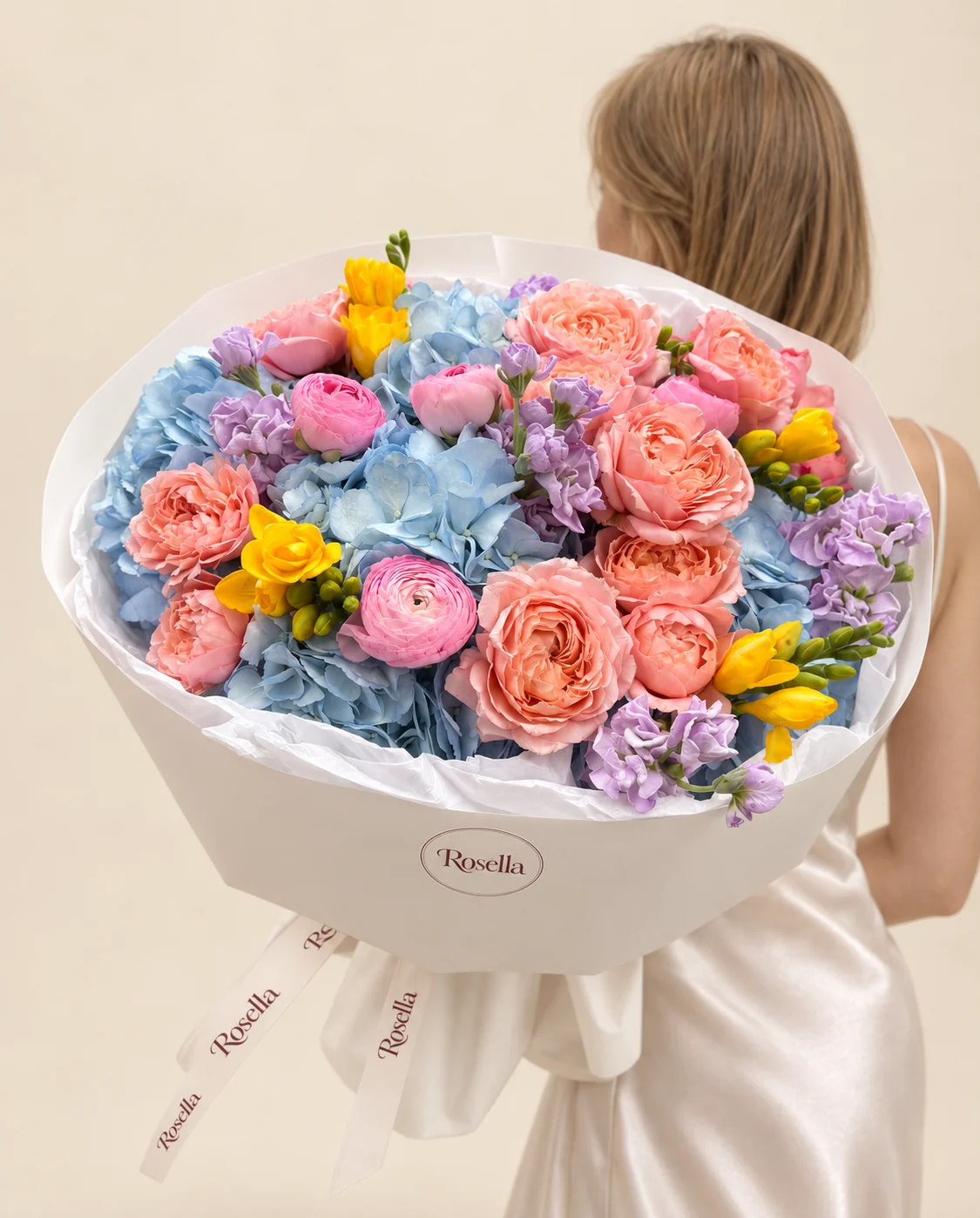 13 garden roses, 5 hydrangeas, 3 stocks, 4 ranunculus & 3 freesias in a hand-tied bouquet