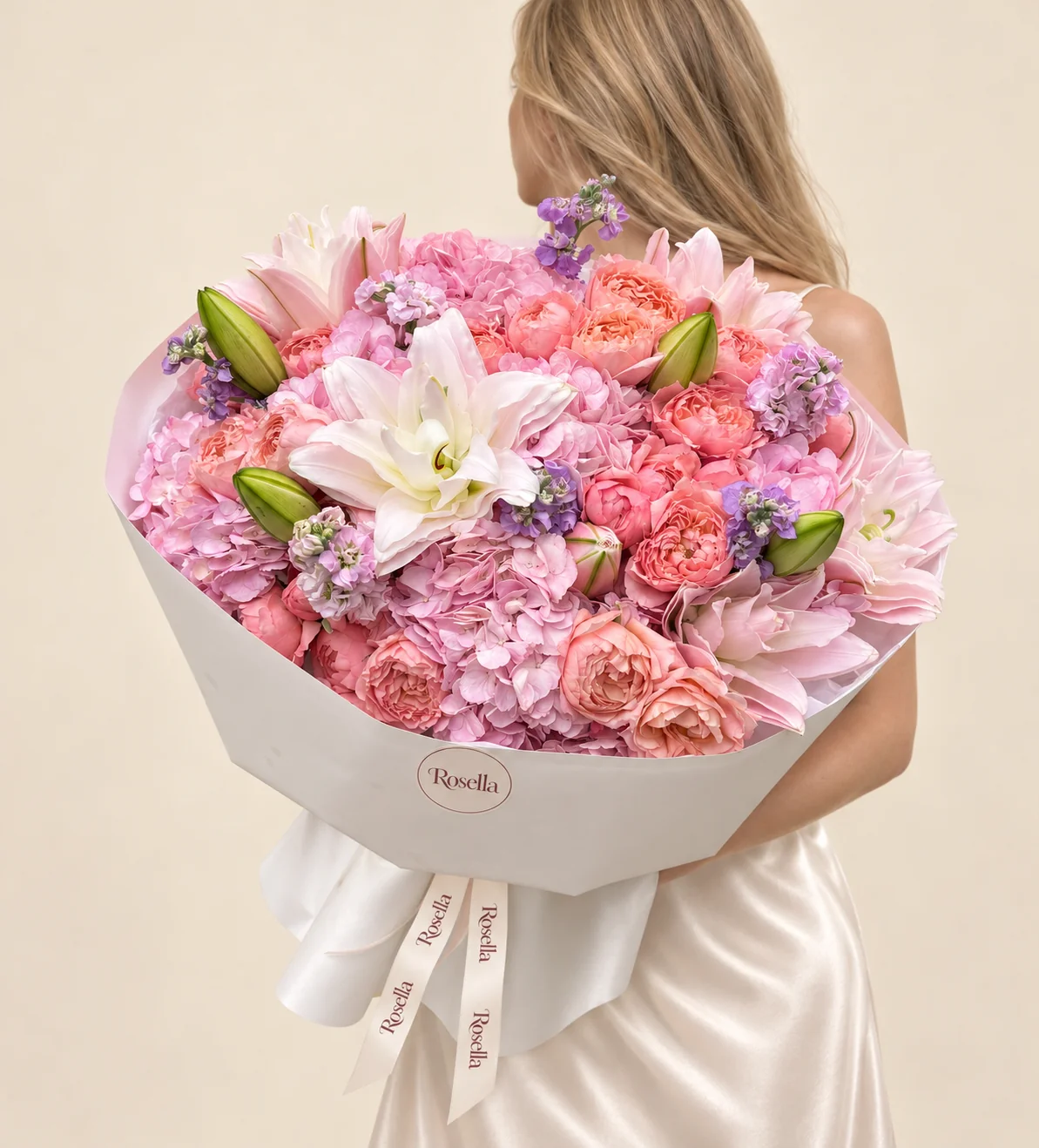 23 garden roses, 6 hydrangeas, 12 lily blooms, 3 lavender stocks & 2 purple stocks in a hand-tied bouquet