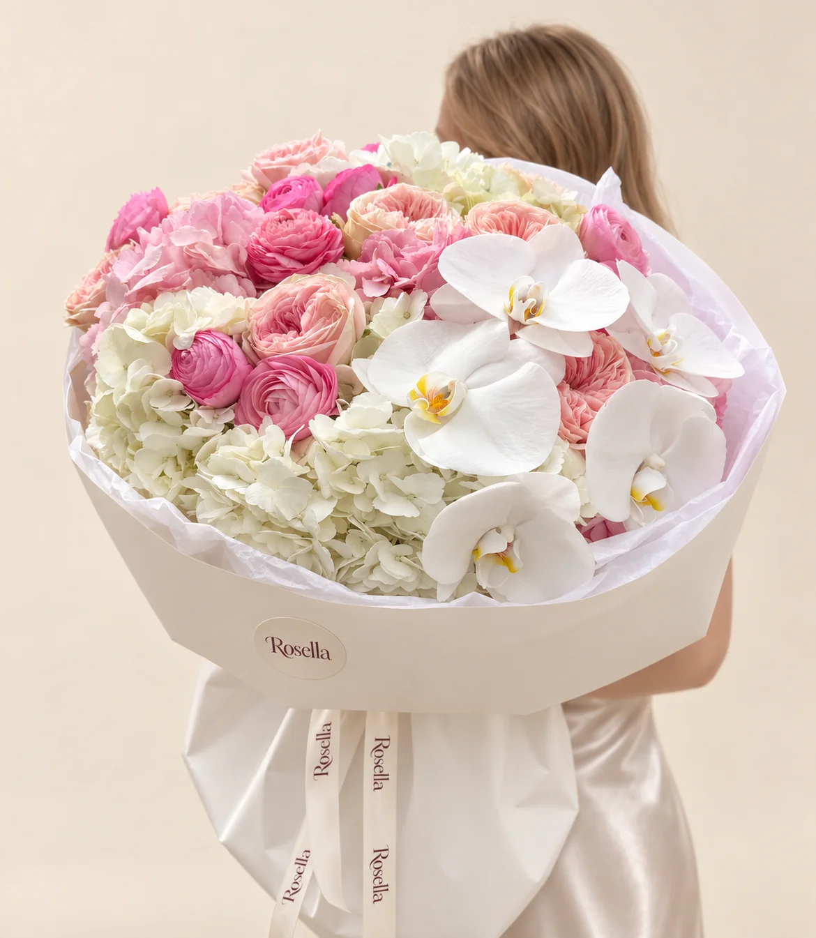 10 garden roses, 4 white hydrangeas, 2 pink hydrangeas, 5 pink ranunculus, 5 orchid blooms & 3 pink ranunculus in a hand-tied bouquet