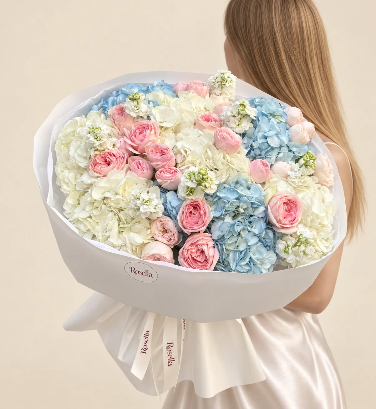 22 blush garden roses, 5 white hydrangeas, 3 blue hydrangeas, 5 stocks & 3 ivory garden roses in a hand-tied bouquet