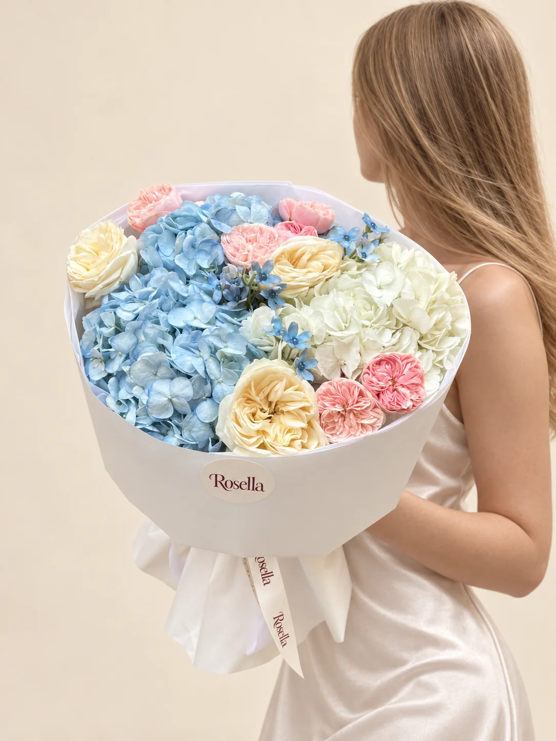 7 pink garden roses, 2 blue hydrangeas, 3 cream garden roses, 1 white hydrangea & 12 tweedia blooms in a hand-tied bouquet