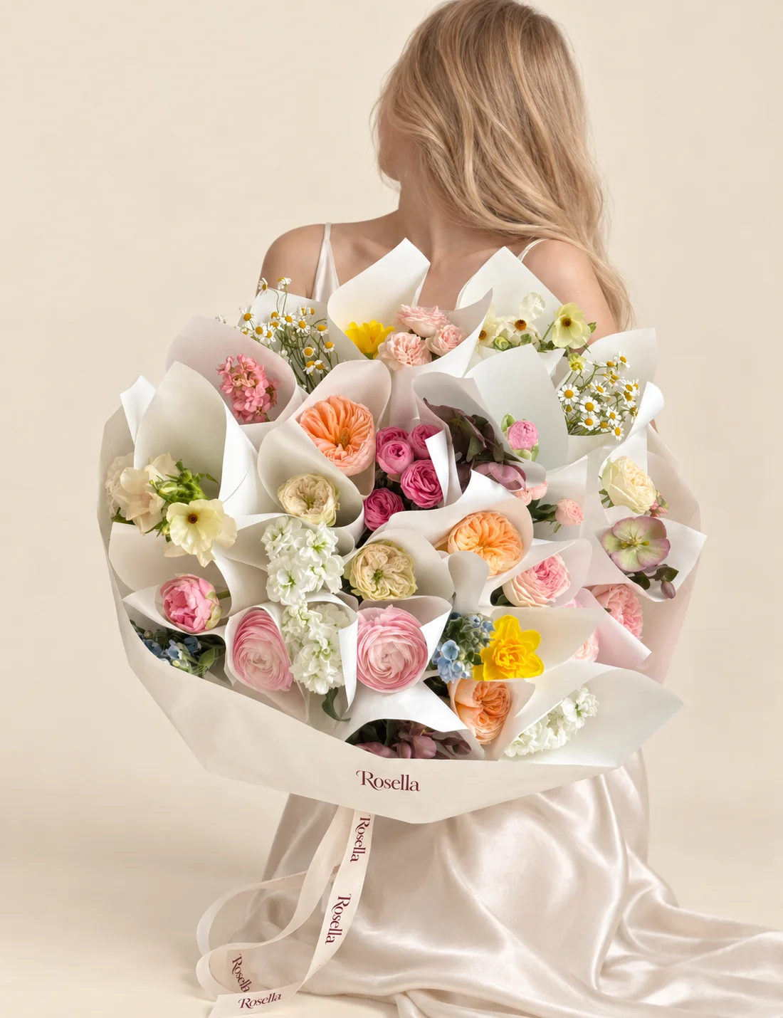 3 peach garden roses, 3 cream garden roses, 3 blush garden roses, 3 white stocks, 2 peonies, 2 yellow double narcissus (daffodil), 46 chamomile blooms, 6 pink spray roses, 6 pink spray roses, 6 dusky pink-purple hellebore, 1 pink stock, 4 cream to pale green hellebore, 2 ranunculus & 12 tweedia blooms in a hand-tied bouquet