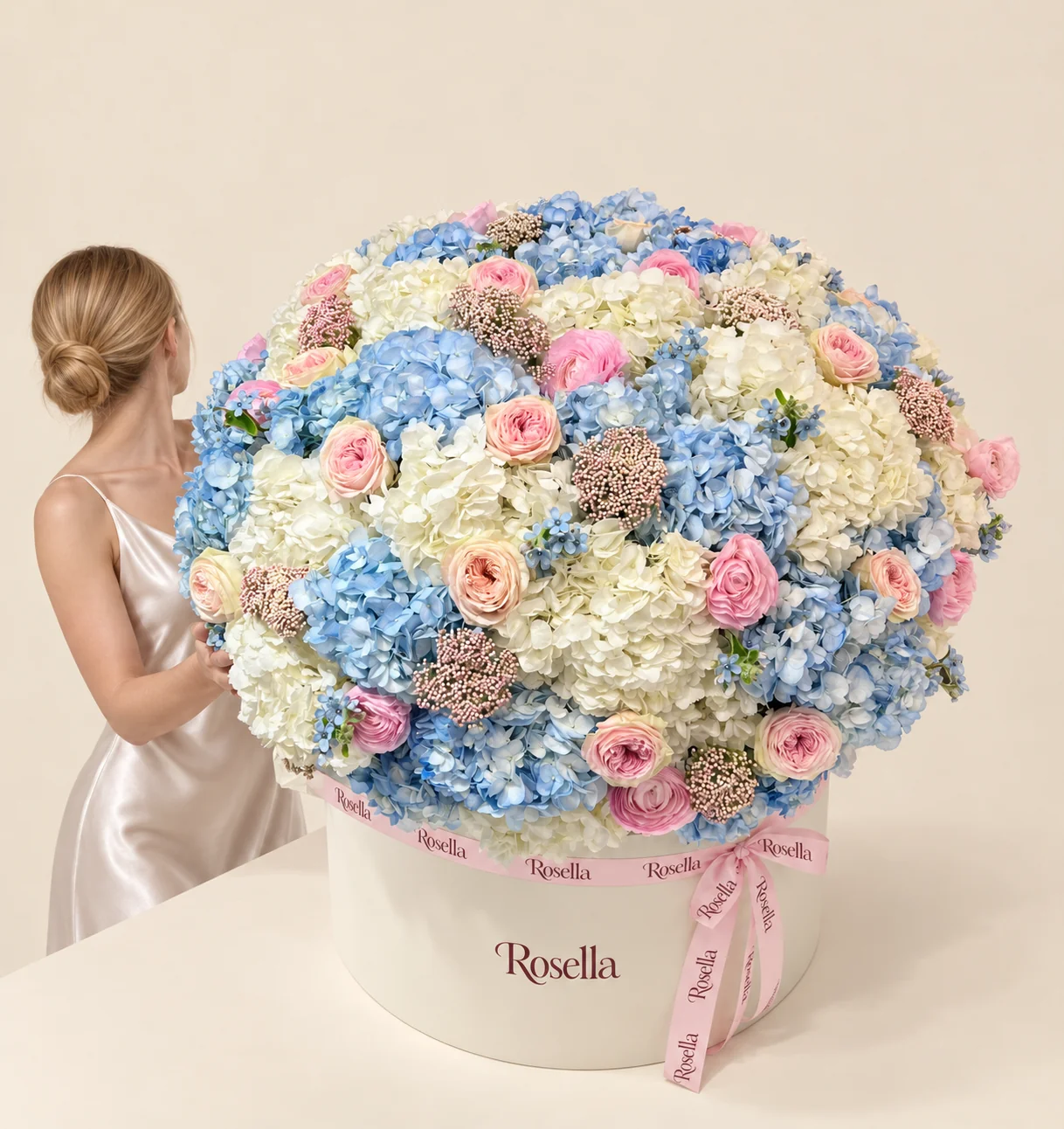 25 blue hydrangeas, 17 white hydrangeas, 14 pink garden roses, 13 blush garden roses, 55 tweedia blooms & 1 rose in a round box