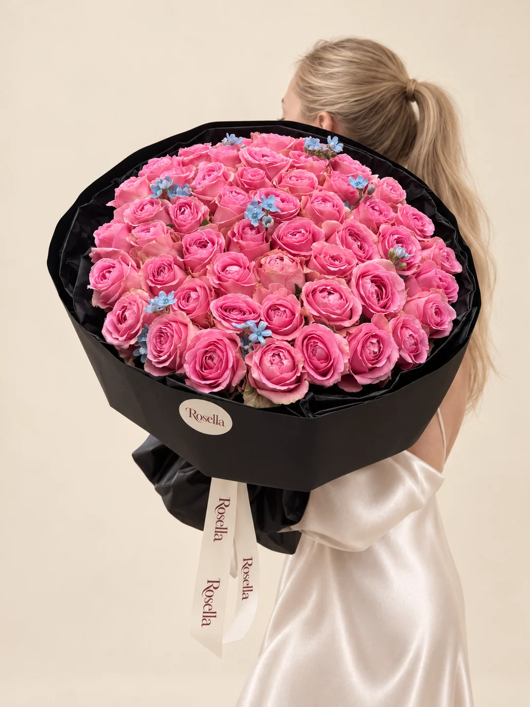 60 roses & 25 tweedia blooms in a hand-tied bouquet