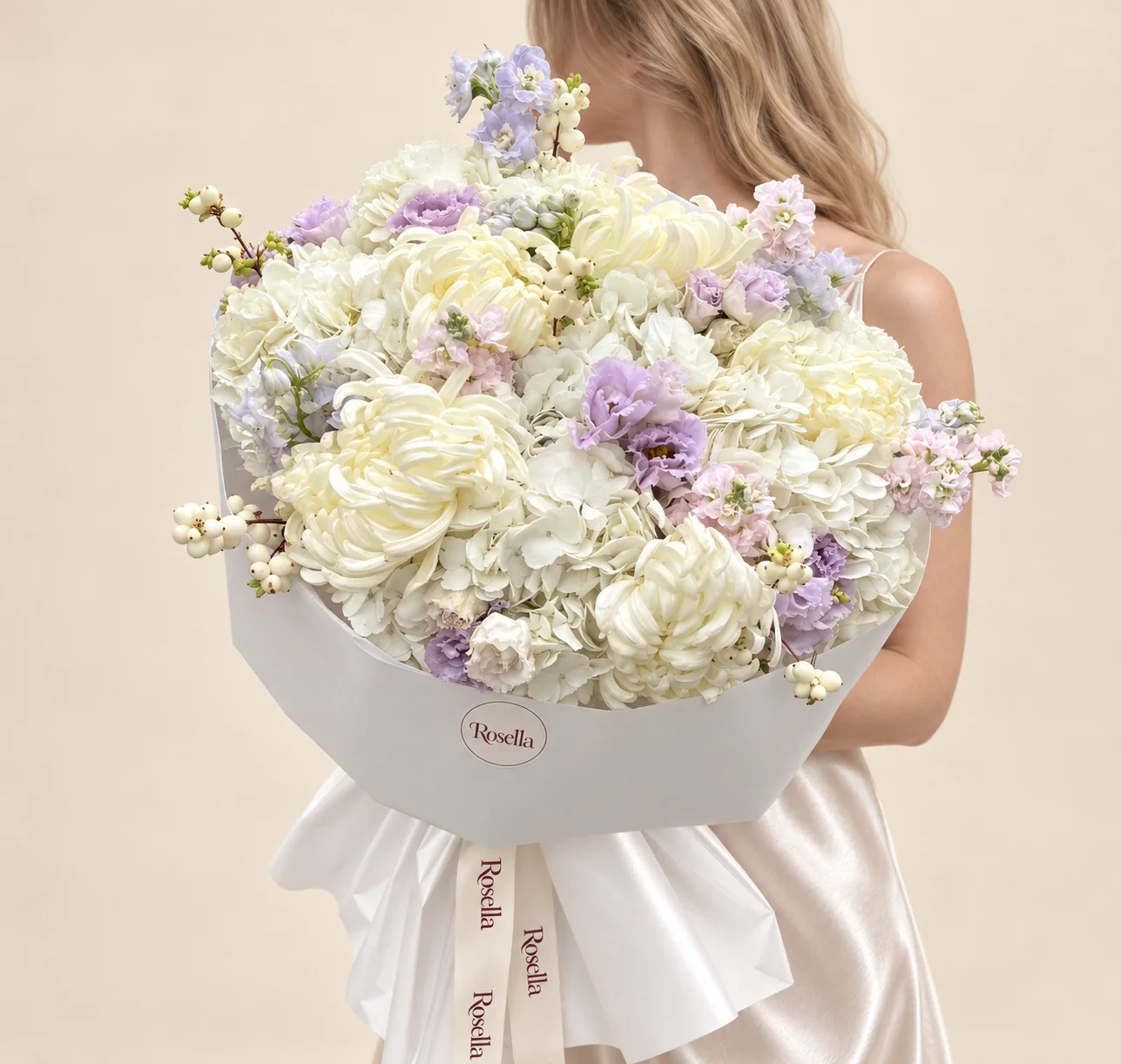 8 hydrangeas, 6 chrysanthemums, 2 delphiniums, 3 stocks, 12 lavender lisianthus blooms & 4 white lisianthus blooms in a hand-tied bouquet