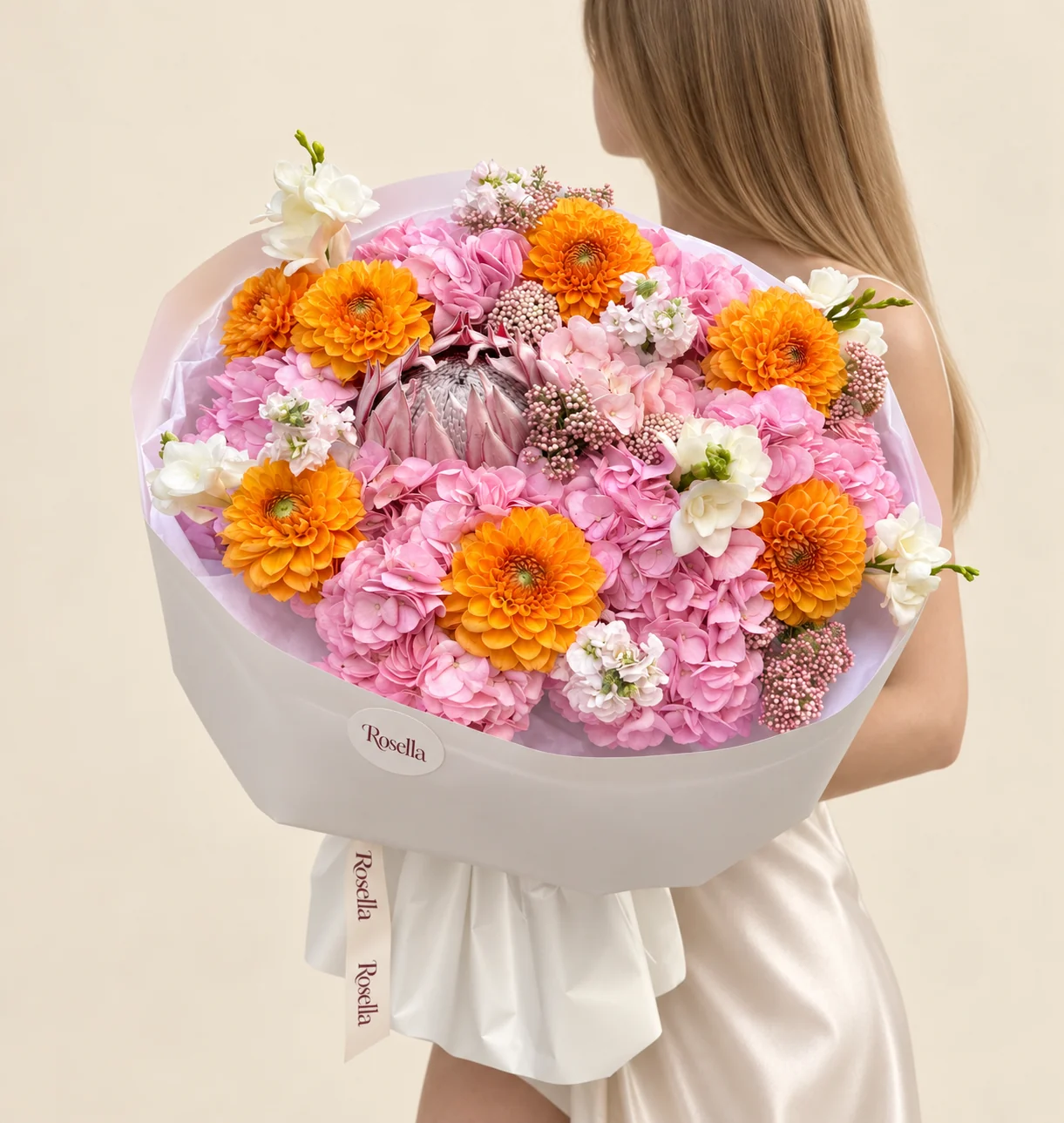 8 hydrangeas, 7 dahlias, 5 freesias, 2 stocks & 1 pink king protea (protea cynaroides) in a hand-tied bouquet