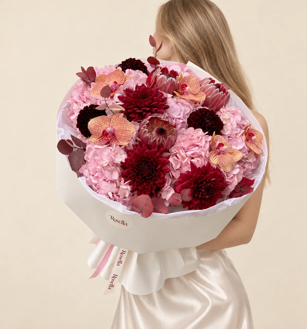 7 hydrangeas, 6 dahlias, 3 pink king protea & 5 orchid blooms in a hand-tied bouquet