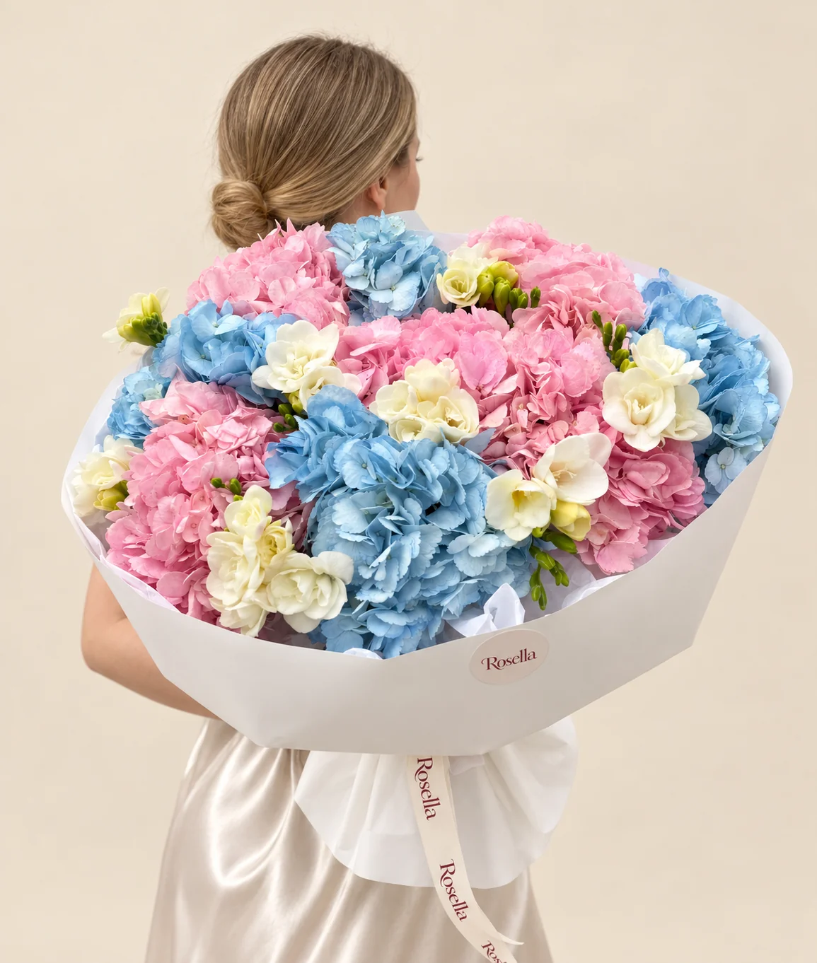 5 pink hydrangeas, 4 blue hydrangeas & 7 freesias in a hand-tied bouquet