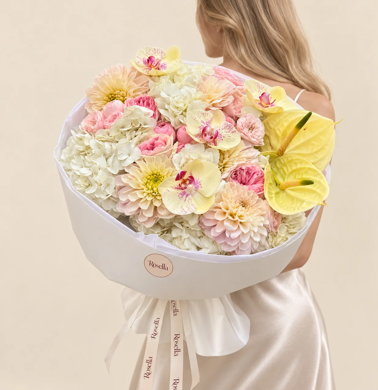 5 hydrangeas, 8 blush garden roses, 6 pink garden roses, 5 dahlias, 4 orchid blooms & 2 anthuriums in a hand-tied bouquet
