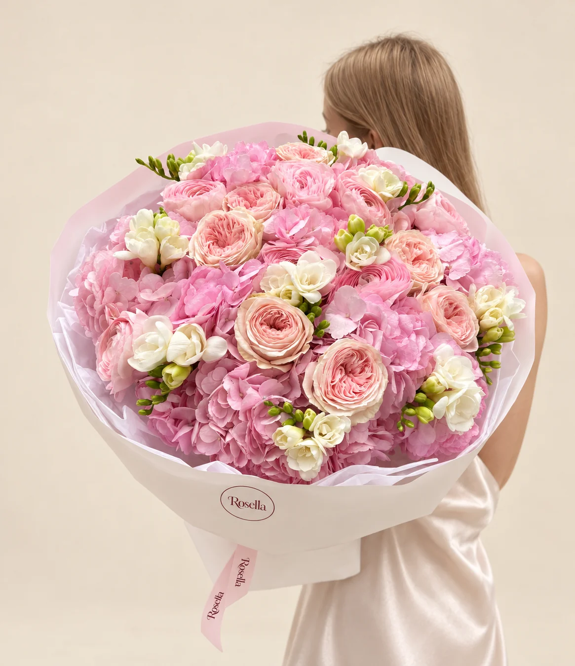 9 hydrangeas, 8 blush garden roses, 8 pink garden roses & 9 freesias in a hand-tied bouquet