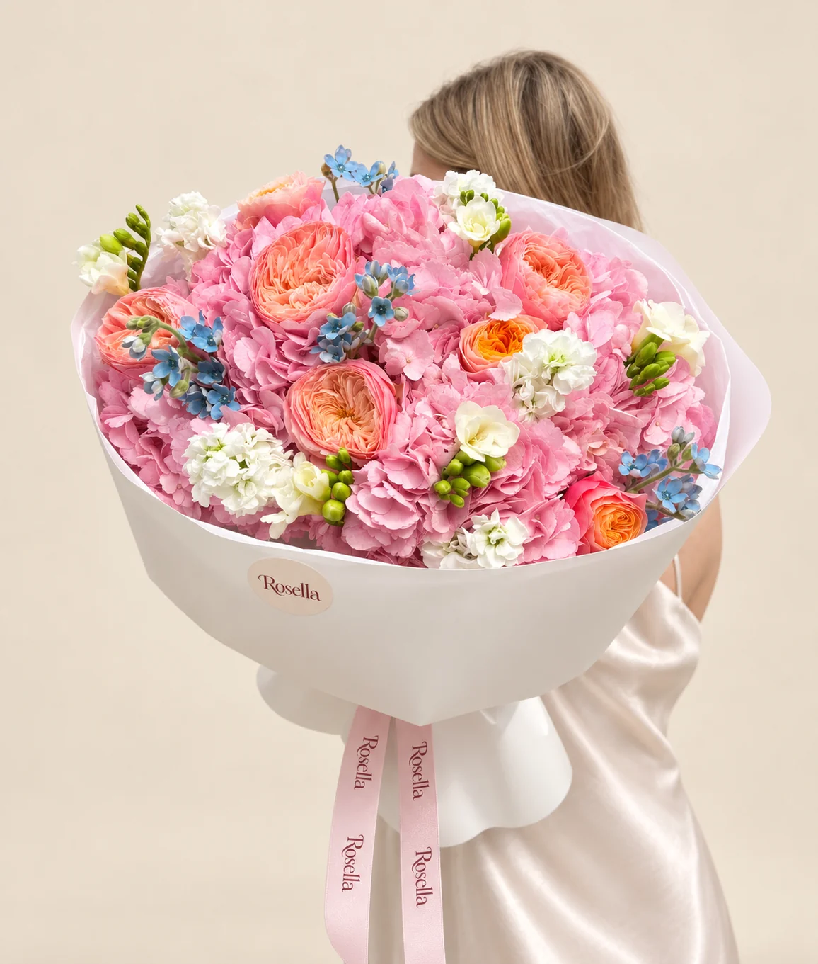 5 hydrangeas, 7 garden roses, 27 tweedia blooms, 2 stocks & 3 freesias in a hand-tied bouquet