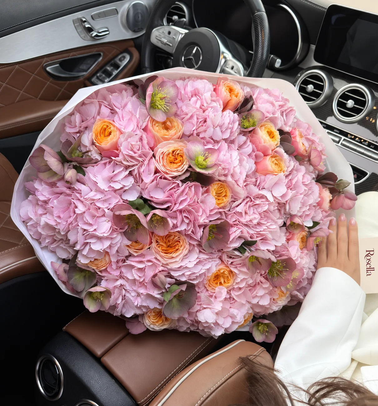 16 hydrangeas, 21 garden roses & 24 helleborus in a hand-tied bouquet
