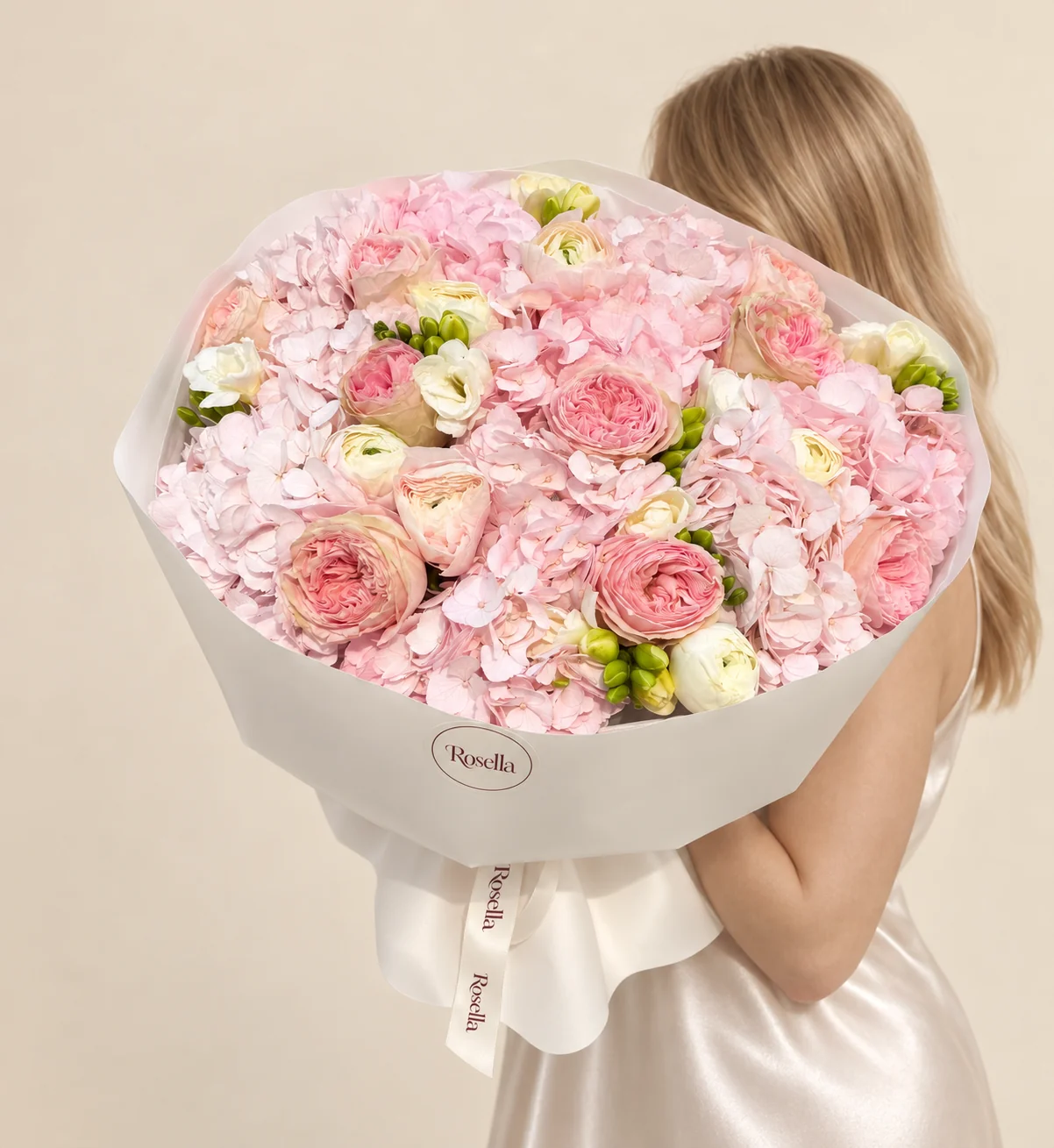 6 hydrangeas, 11 garden roses, 6 ivory ranunculus, 4 freesias & 1 peach ranunculus in a hand-tied bouquet