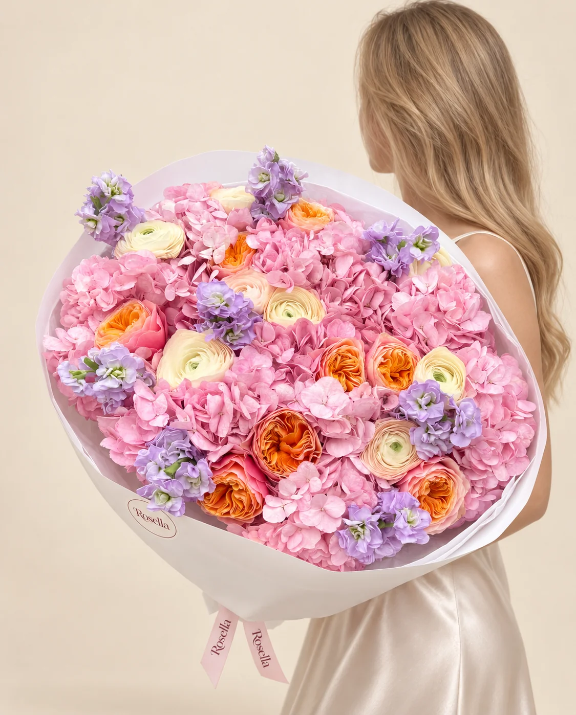 10 hydrangeas, 9 garden roses, 4 stocks, 7 cream ranunculus & 2 blush ranunculus in a hand-tied bouquet