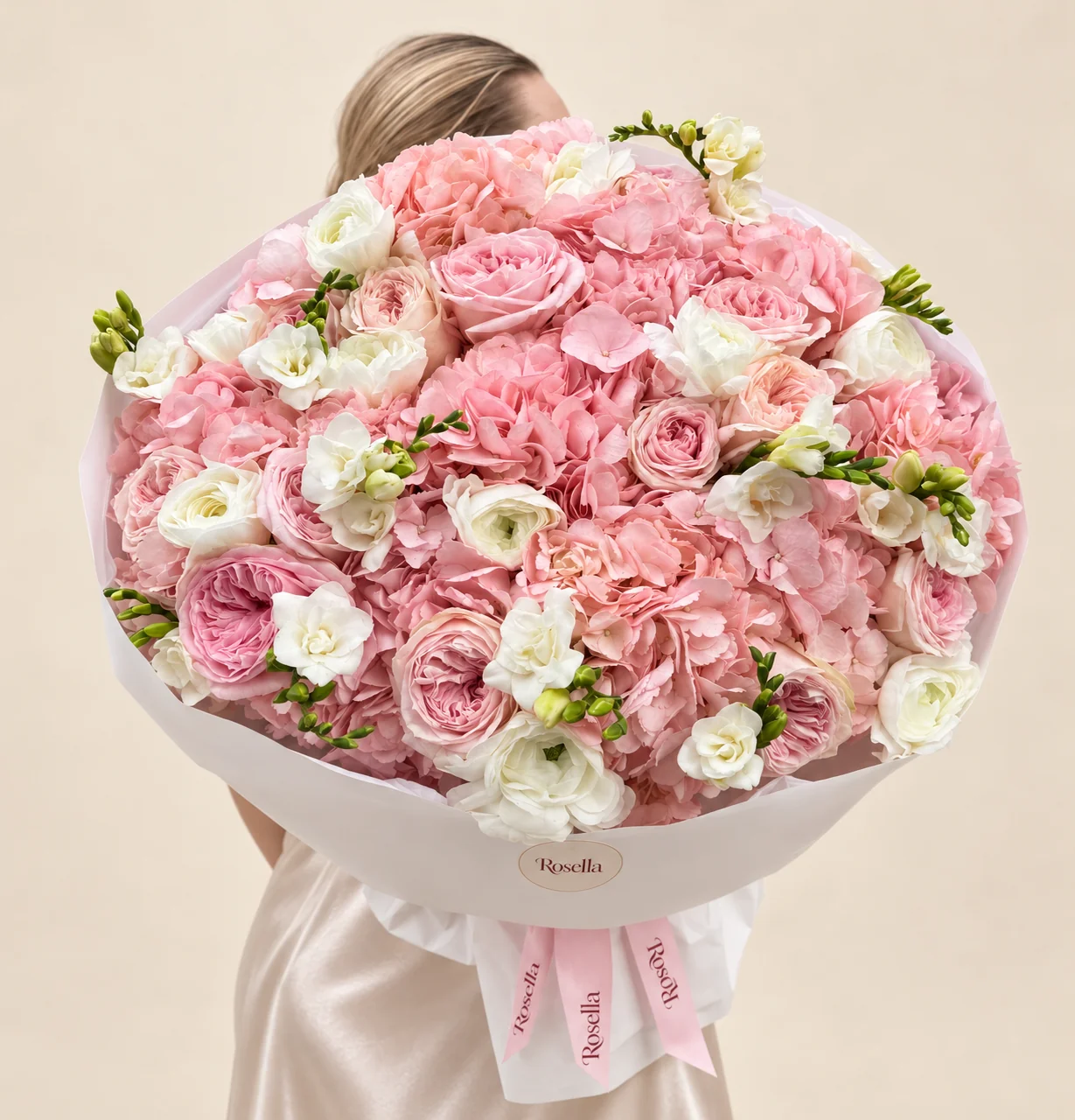 9 hydrangeas, 11 pink garden roses, 12 ranunculus, 3 blush garden roses & 5 freesias in a hand-tied bouquet