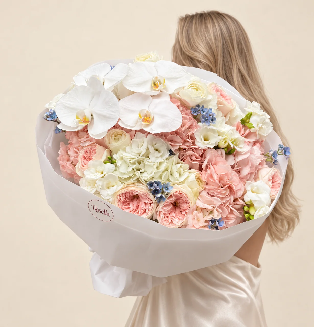 5 blush hydrangeas, 6 garden roses, 5 roses, 1 white hydrangea, 24 tweedia blooms, 4 orchid blooms & 4 freesias in a hand-tied bouquet
