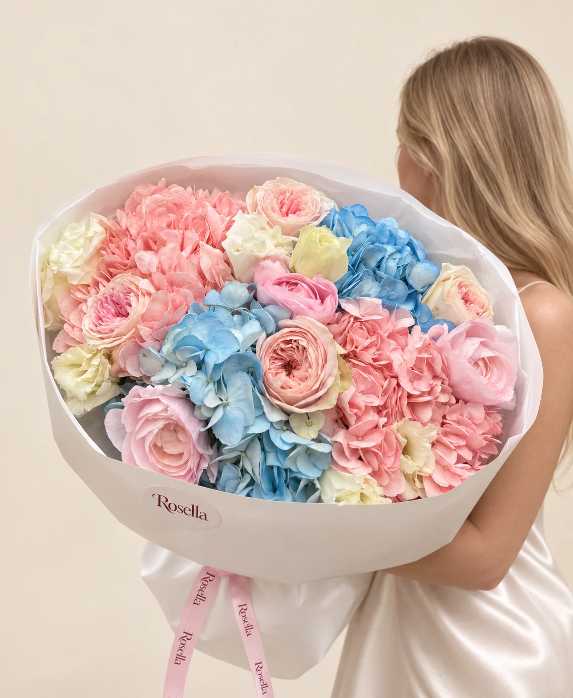 2 pink hydrangeas, 2 blue hydrangeas, 4 garden roses, 3 roses & 8 lisianthus blooms in a hand-tied bouquet