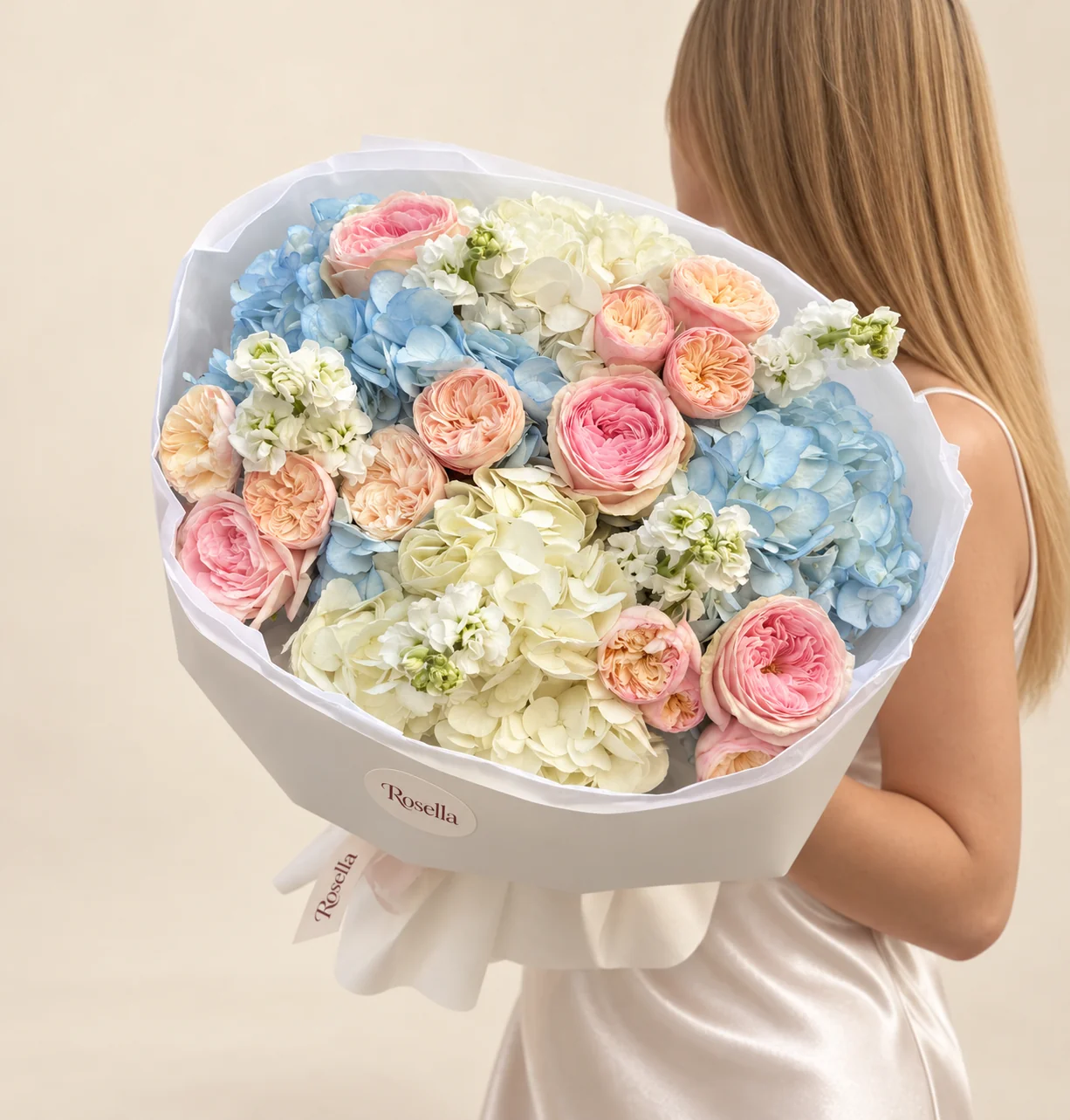 3 blue hydrangeas, 3 ivory hydrangeas, 5 garden roses, 12 spray roses & 3 stocks in a hand-tied bouquet