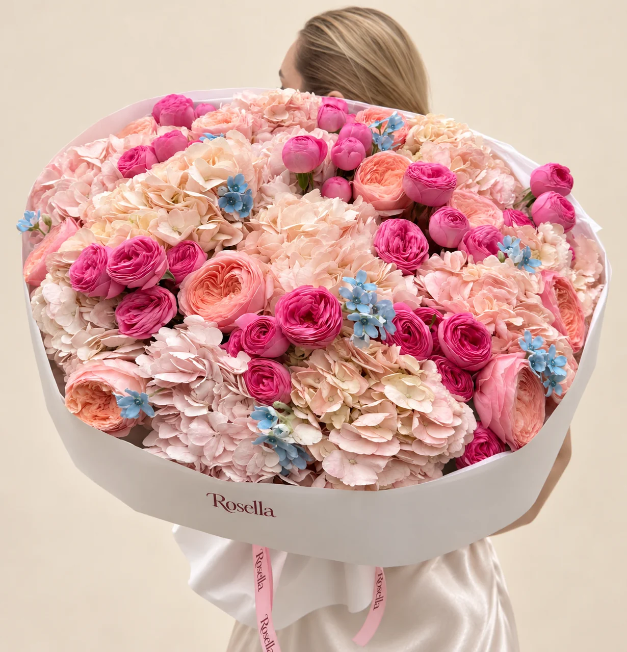 11 hydrangeas, 13 garden roses, 35 spray roses & 36 tweedia blooms in a hand-tied bouquet