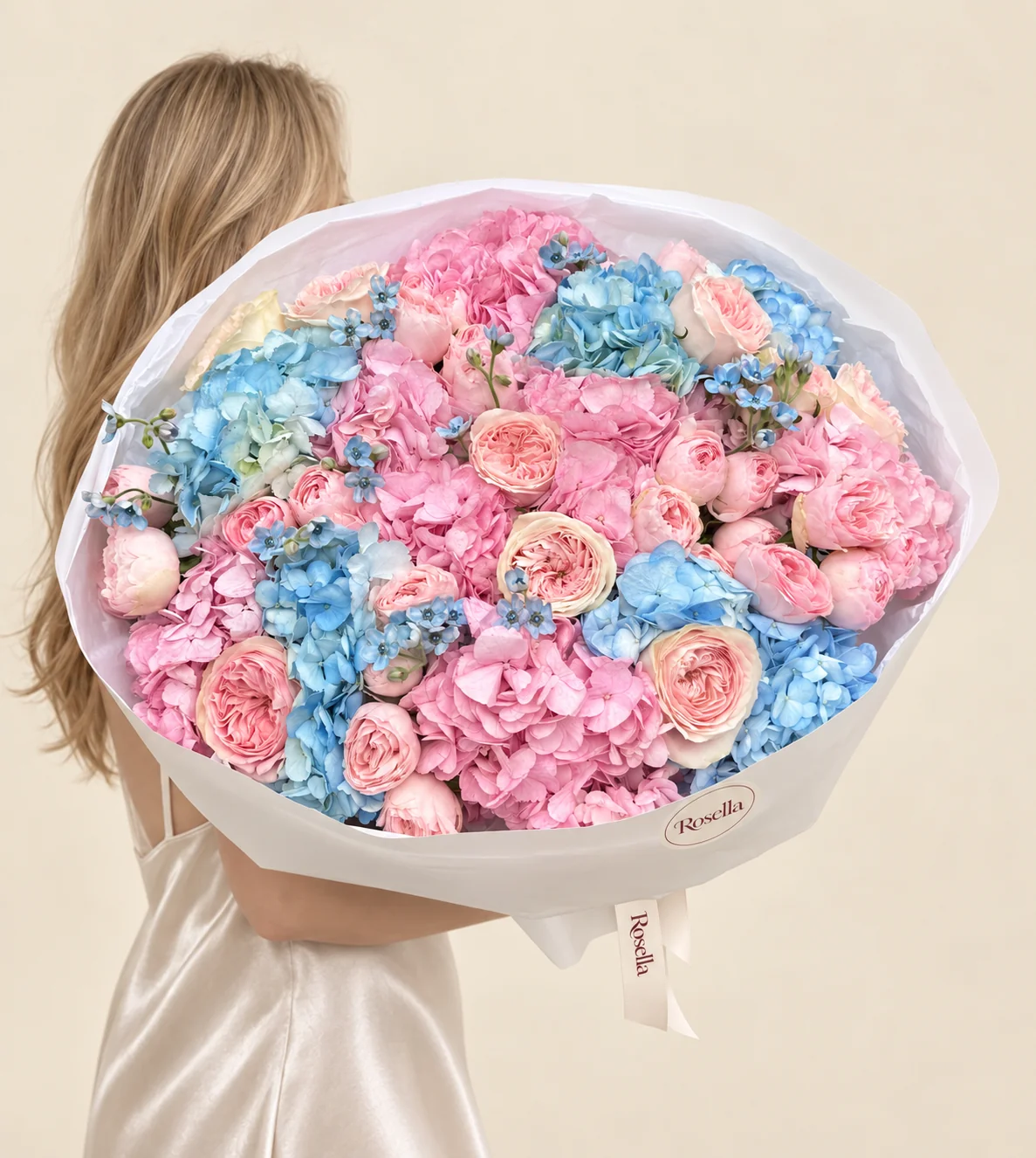8 pink hydrangeas, 7 blue hydrangeas, 10 garden roses, 22 spray roses & 30 tweedia blooms in a hand-tied bouquet