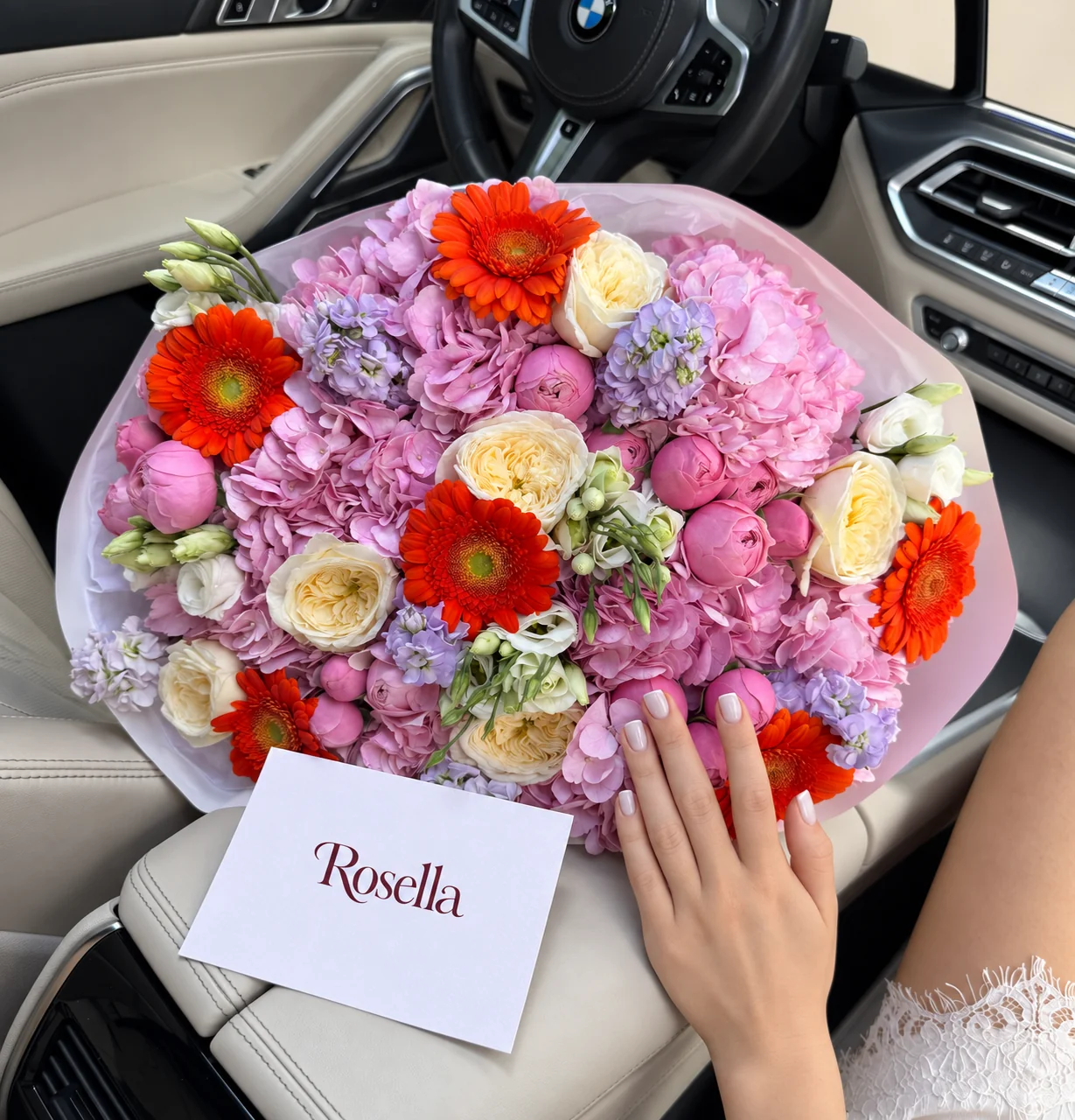 6 hydrangeas, 7 garden roses, 18 spray roses, 4 stocks, 6 gerberas & 13 lisianthus blooms in a hand-tied bouquet