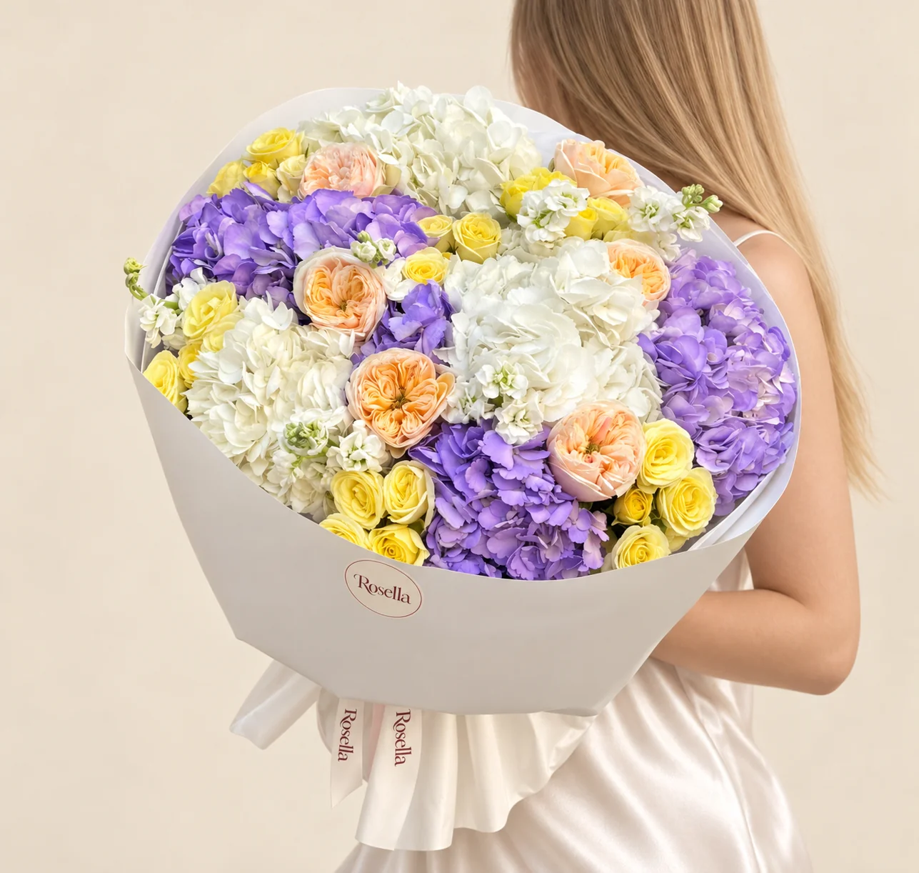 4 lavender hydrangeas, 3 white hydrangeas, 7 garden roses, 26 spray roses & 3 stocks in a hand-tied bouquet