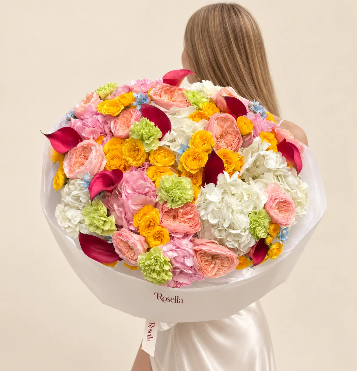 6 white hydrangeas, 6 pink hydrangeas, 13 garden roses, 36 spray roses, 10 callas, 8 carnations & 22 tweedia blooms in a hand-tied bouquet