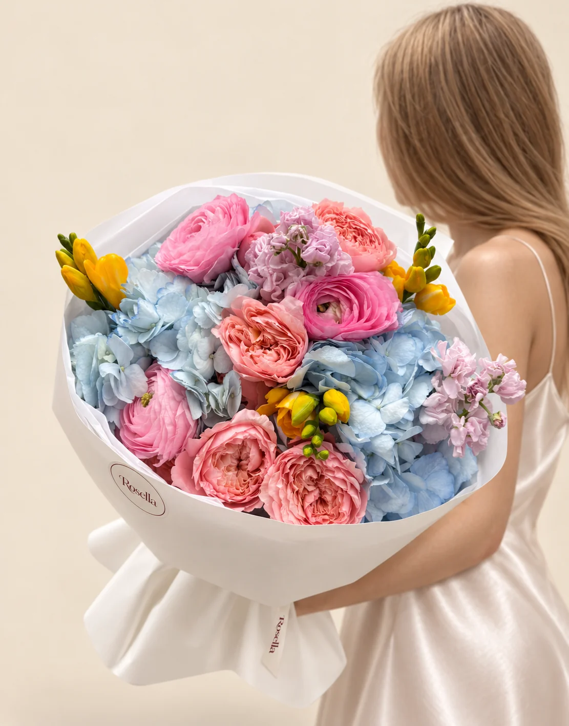 2 hydrangeas, 4 garden roses, 2 stocks, 4 freesias & 3 ranunculus in a hand-tied bouquet