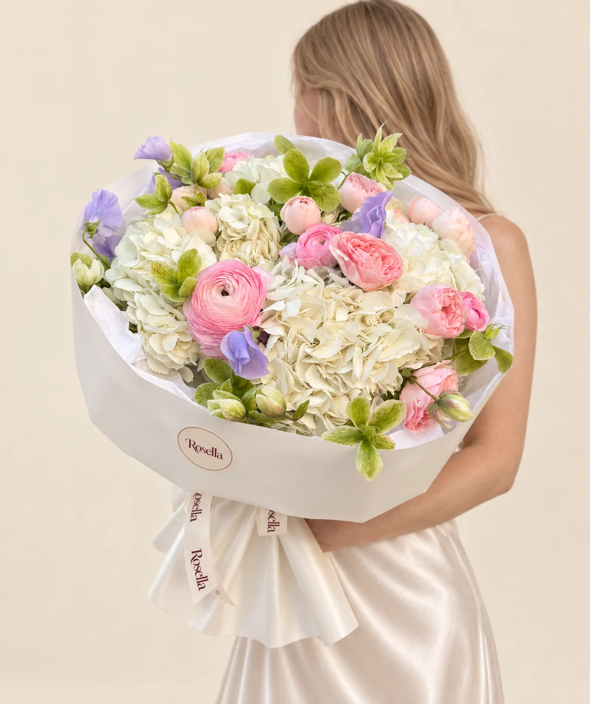 6 hydrangeas, 8 garden roses, 18 green hellebore, 7 ranunculus & 8 lavender sweet pea in a hand-tied bouquet