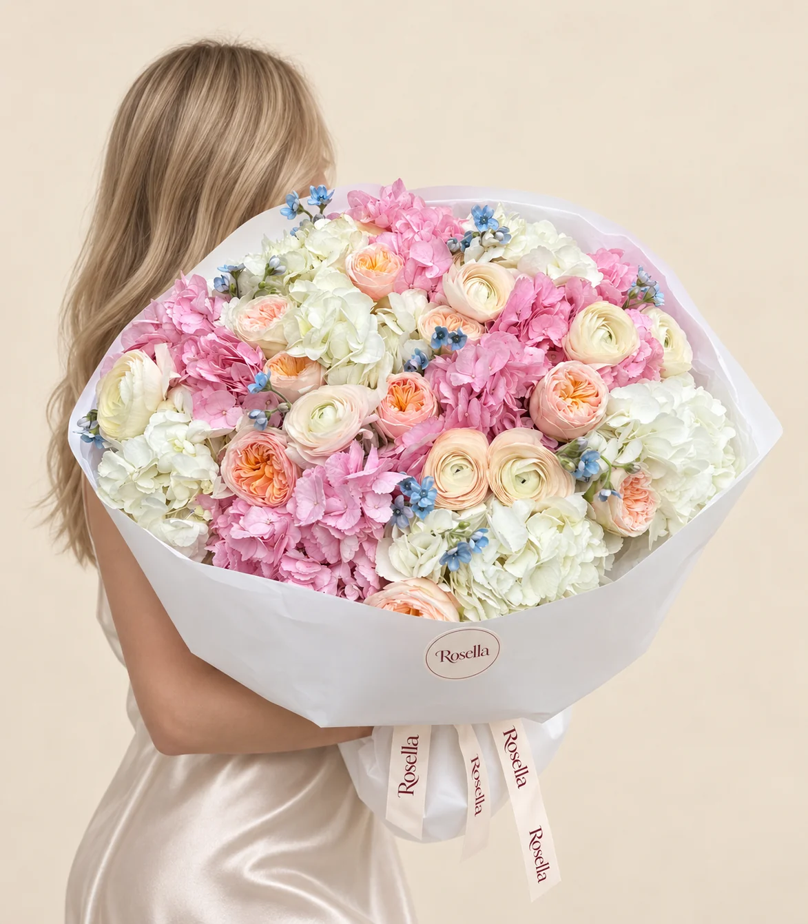 7 white hydrangeas, 6 pink hydrangeas, 11 garden roses, 8 ranunculus & 33 tweedia blooms in a hand-tied bouquet