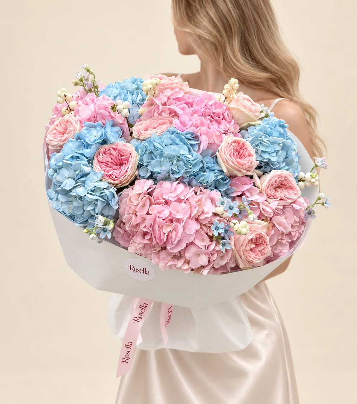 5 blue hydrangeas, 5 pink hydrangeas, 10 garden roses, 12 blue tweedia blooms & 3 white tweedia blooms in a hand-tied bouquet