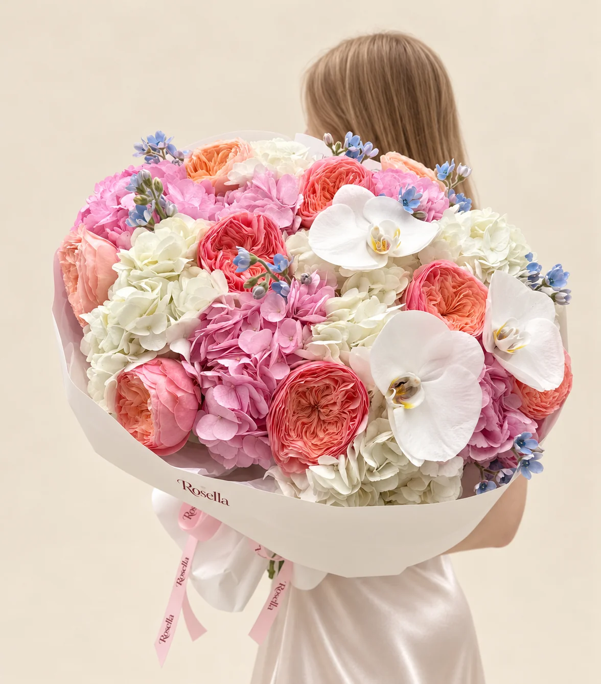 6 white hydrangeas, 6 pink hydrangeas, 9 coral garden roses, 4 peach garden roses, 26 tweedia blooms & 3 orchid blooms in a hand-tied bouquet