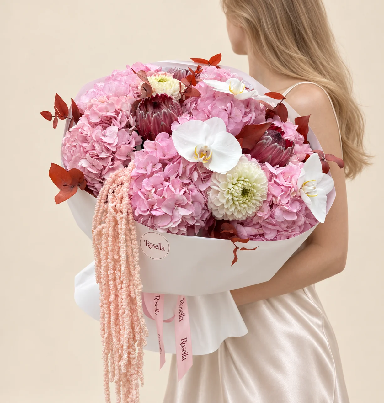 6 hydrangeas, 3 burgundy-pink king protea, 2 dahlias & 3 orchid blooms in a hand-tied bouquet