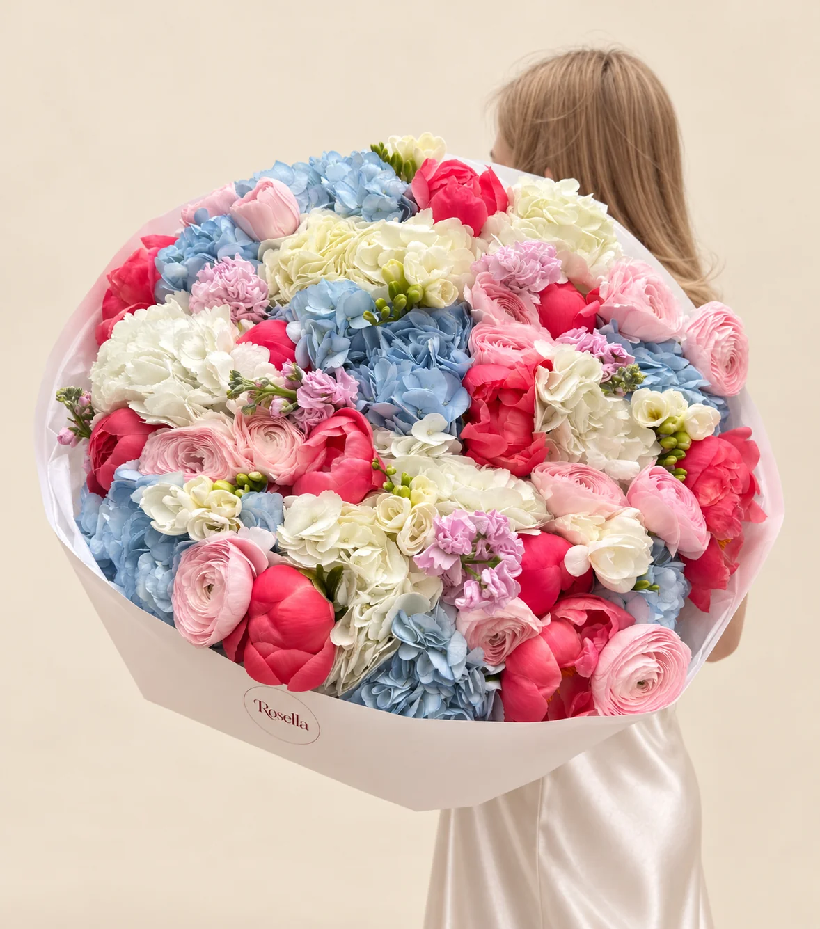 8 blue hydrangeas, 7 cream hydrangeas, 13 peonies, 15 ranunculus, 6 freesias & 2 stocks in a hand-tied bouquet