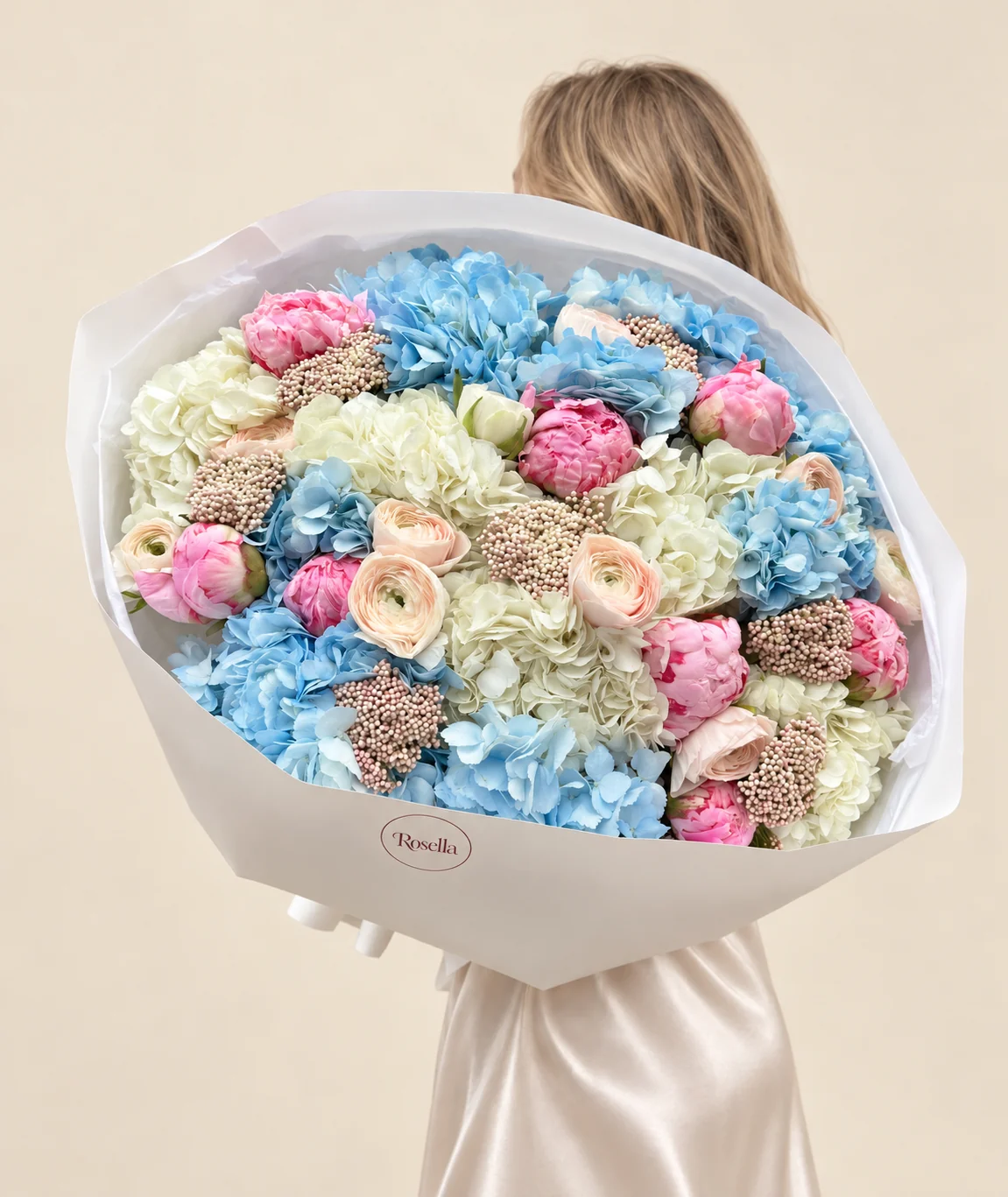 8 blue hydrangeas, 6 ivory hydrangeas, 10 peonies & 12 ranunculus in a hand-tied bouquet