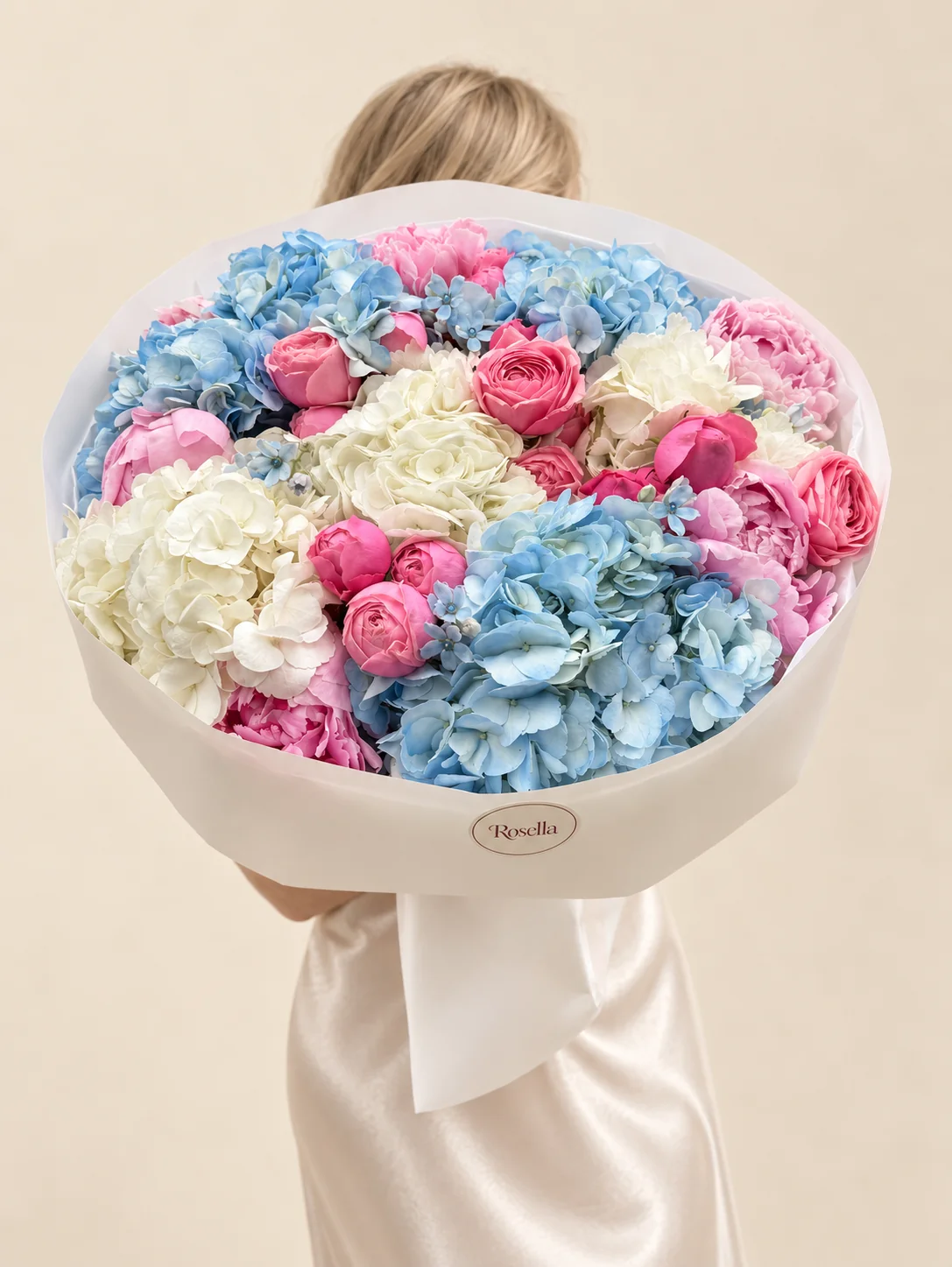 5 blue hydrangeas, 7 peonies, 3 white hydrangeas, 15 spray roses & 9 tweedia blooms in a hand-tied bouquet