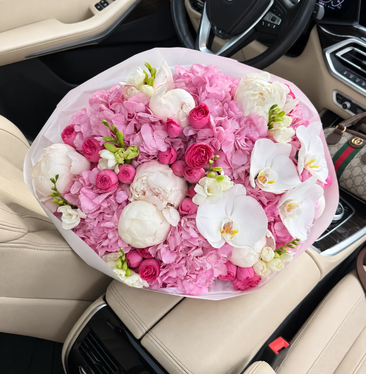 7 hydrangeas, 6 peonies, 23 spray roses, 6 freesias & 4 orchid blooms in a hand-tied bouquet