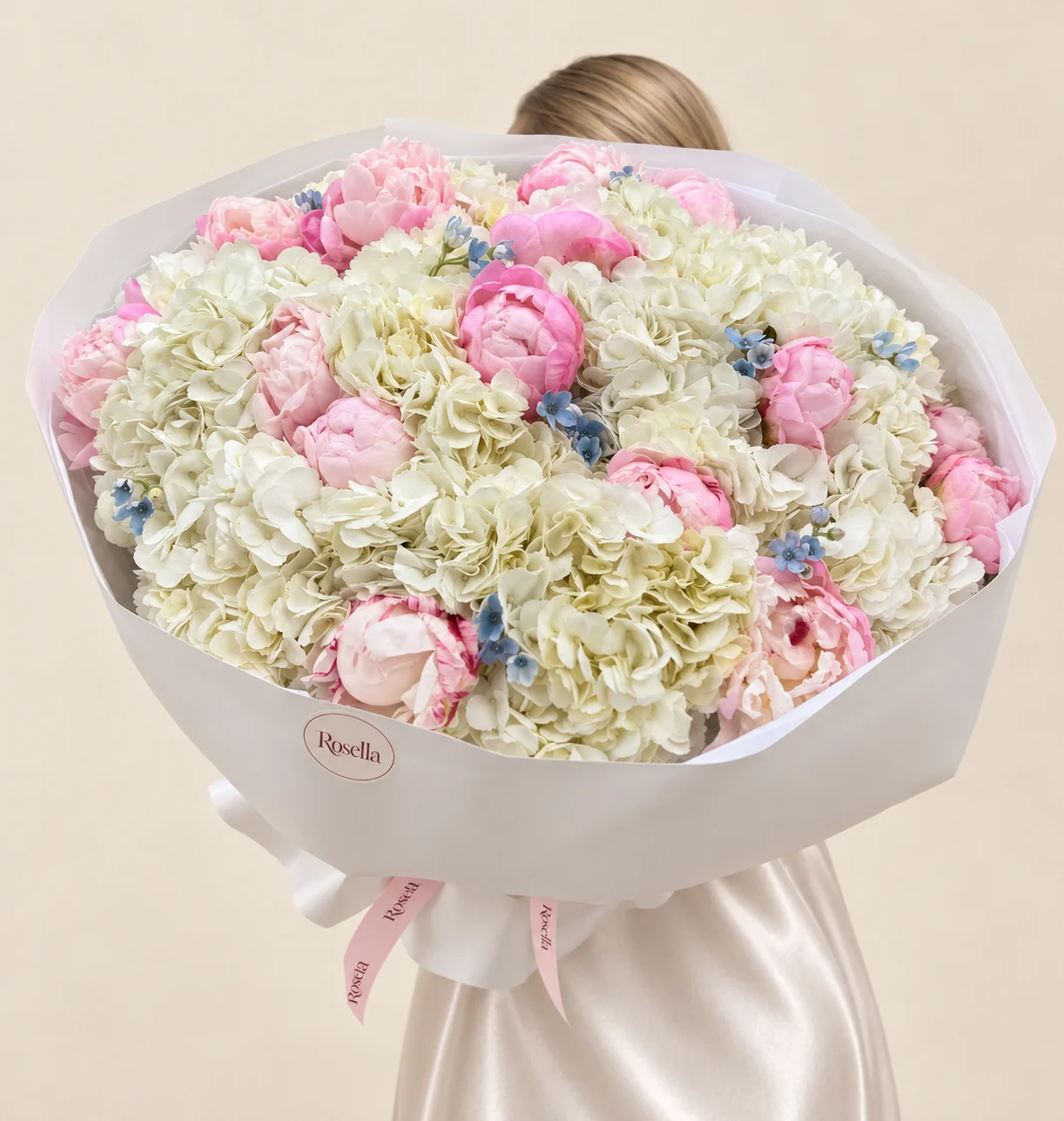 15 hydrangeas, 21 peonies & 32 tweedia blooms in a hand-tied bouquet