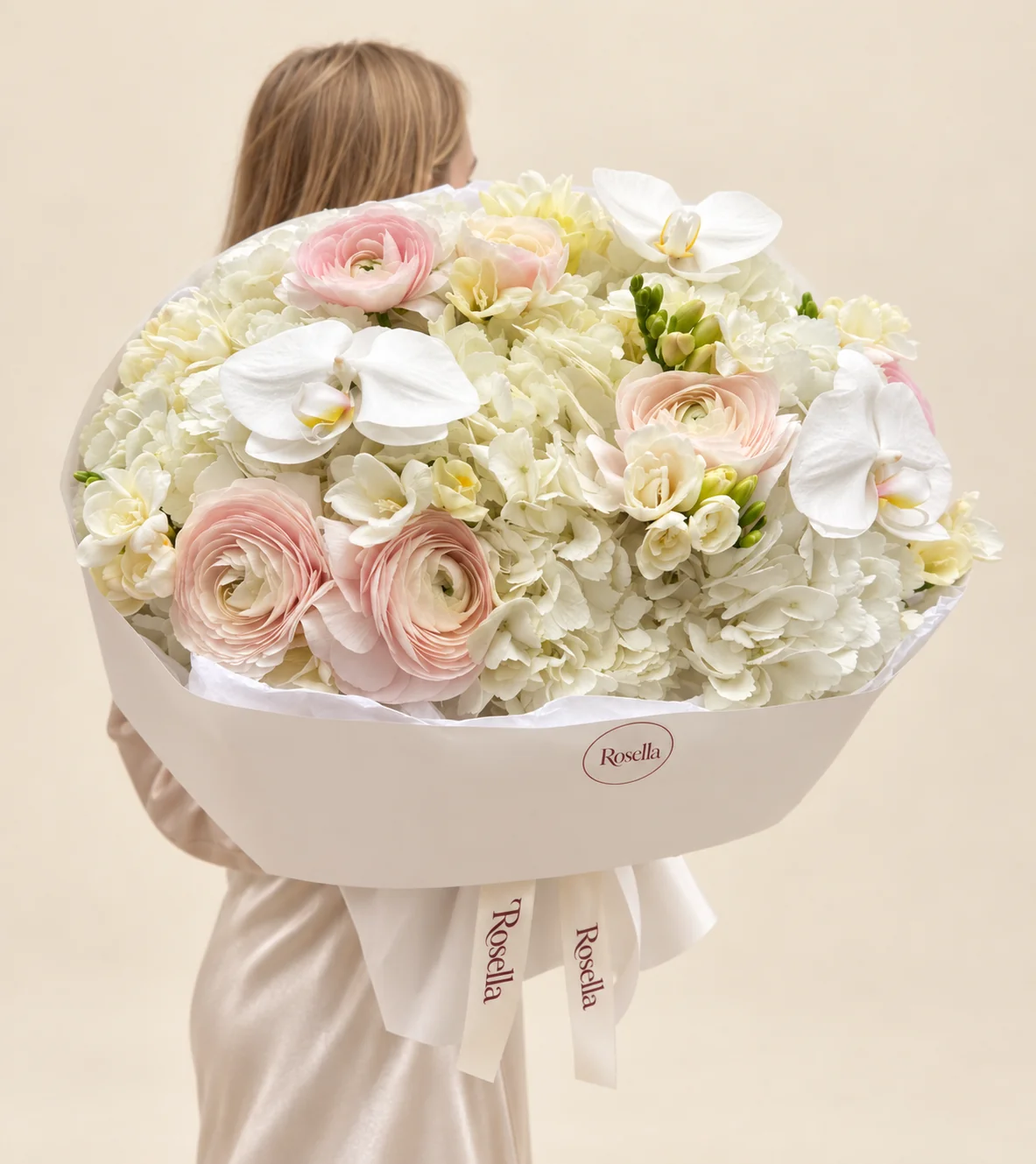 6 hydrangeas, 7 ranunculus, 6 freesias & 3 orchid blooms in a hand-tied bouquet