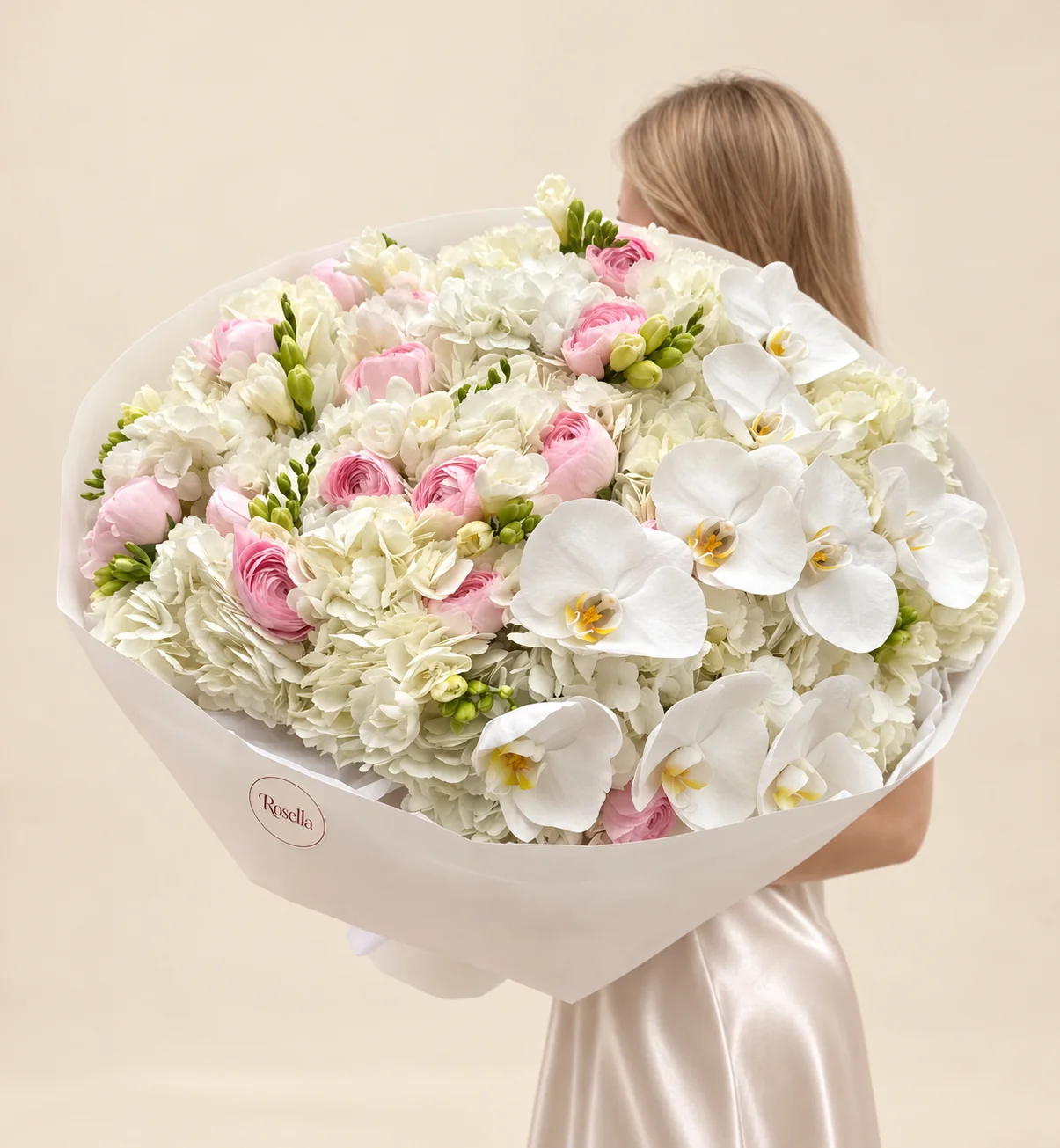 10 hydrangeas, 16 ranunculus, 10 orchid blooms & 6 freesias in a hand-tied bouquet