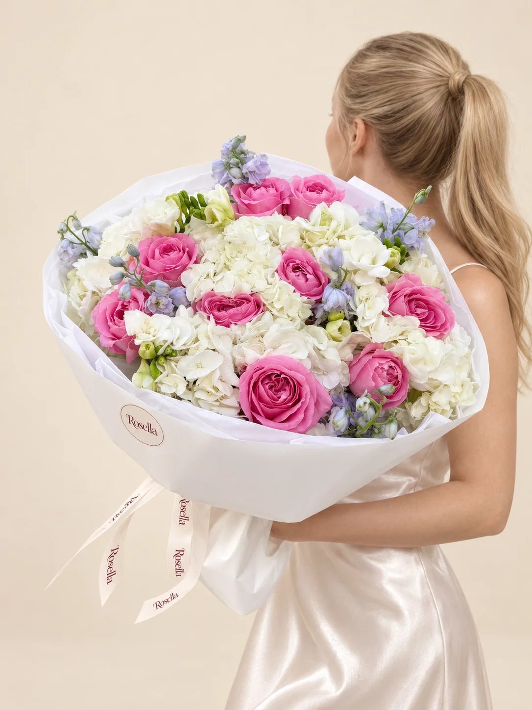 6 hydrangeas, 10 roses, 2 delphiniums & 3 freesias in a hand-tied bouquet