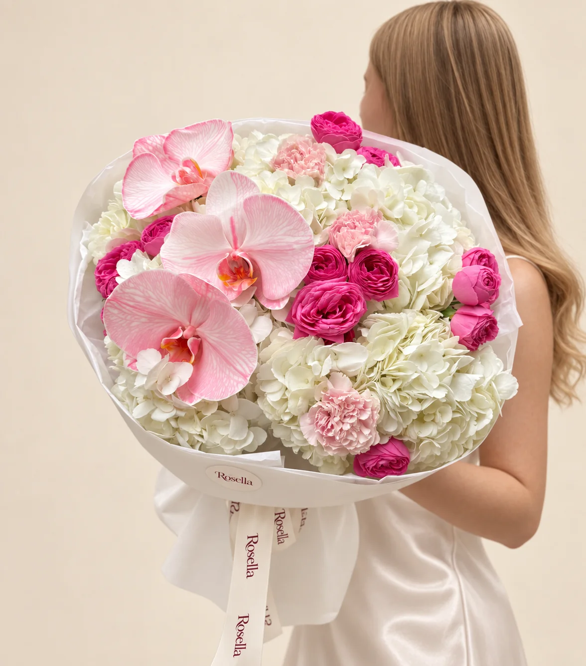 7 hydrangeas, 13 roses, 3 orchid blooms & 3 carnations in a hand-tied bouquet