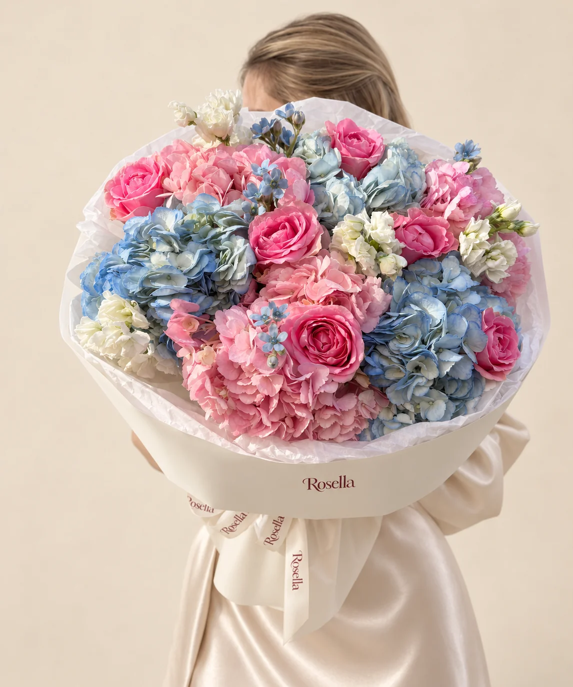 3 blue hydrangeas, 3 pink hydrangeas, 7 roses, 2 stocks & 13 tweedia blooms in a hand-tied bouquet