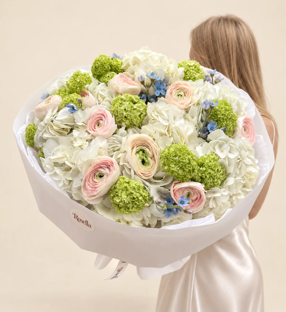 10 hydrangeas, 14 lime-green snowball viburnum, 6 peach ranunculus, 5 blush ranunculus & 22 tweedia blooms in a hand-tied bouquet