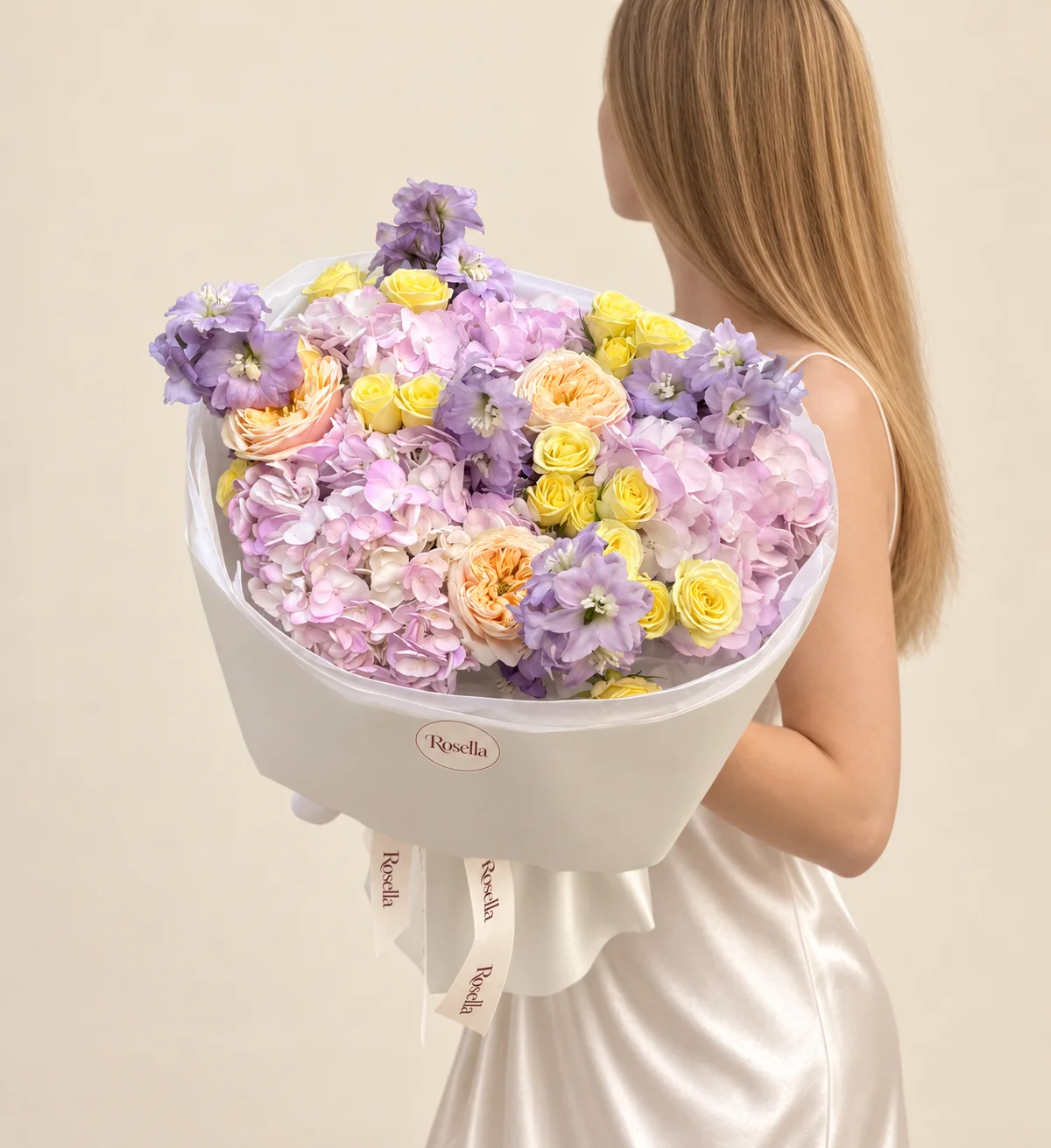 3 hydrangeas, 20 spray roses, 2 delphiniums & 3 garden roses in a hand-tied bouquet