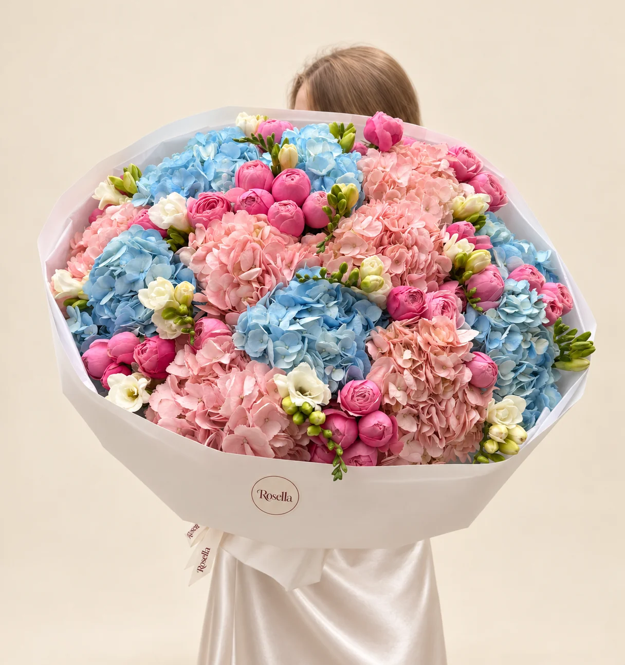 7 blue hydrangeas, 7 blush hydrangeas, 40 spray roses & 6 freesias in a hand-tied bouquet