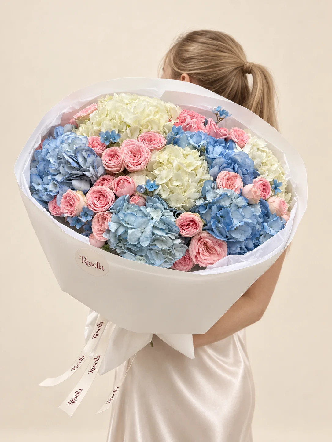 4 blue hydrangeas, 4 white hydrangeas, 29 spray roses & 20 tweedia blooms in a hand-tied bouquet