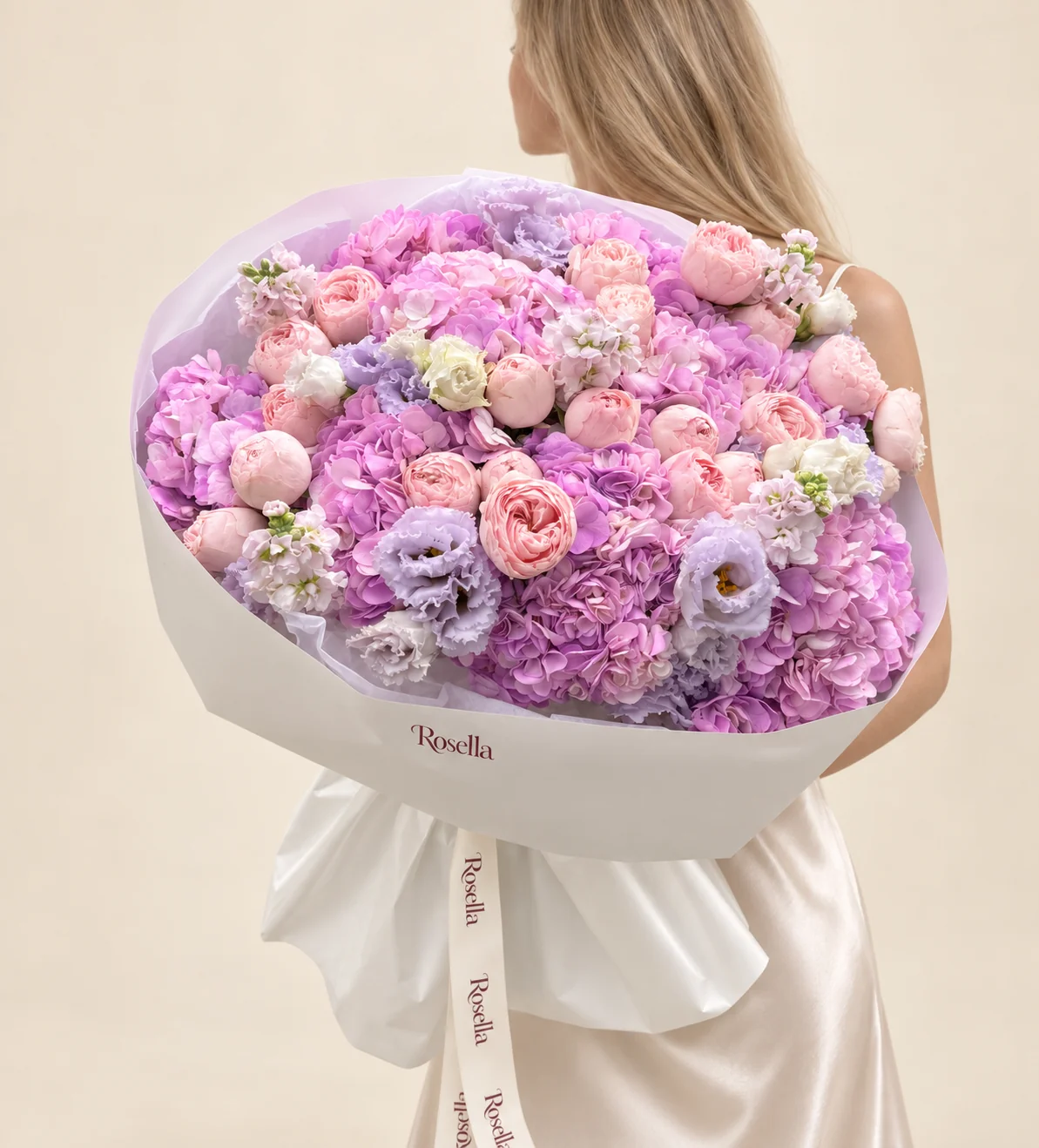 10 hydrangeas, 24 spray roses, 15 lavender lisianthus blooms, 3 stocks & 7 white lisianthus blooms in a hand-tied bouquet