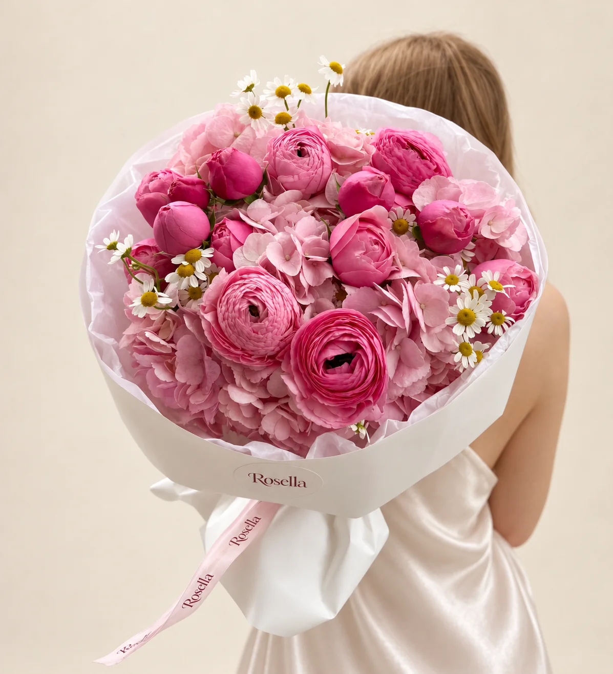 4 hydrangeas, 12 spray roses, 26 chamomile blooms, 2 pink ranunculus & 2 pink ranunculus in a hand-tied bouquet
