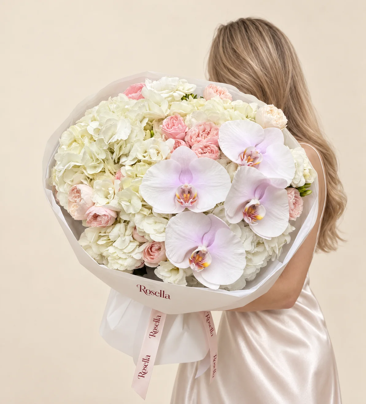 6 hydrangeas, 15 blush spray roses, 4 orchid blooms, 2 freesias & 2 cream spray roses in a hand-tied bouquet